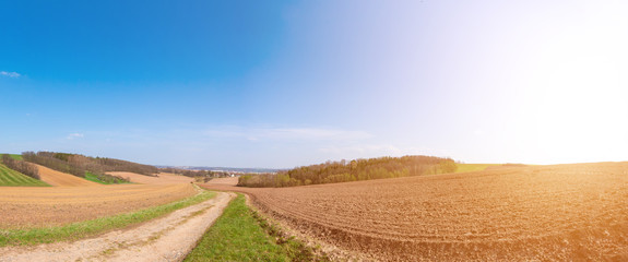 Fototapeta na wymiar Panorama of spring plowed field