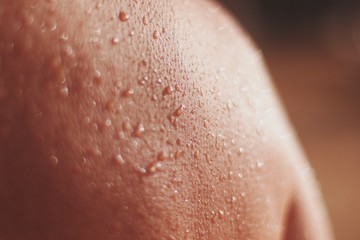 Fototapeta premium closeup of female skin with drops of a water