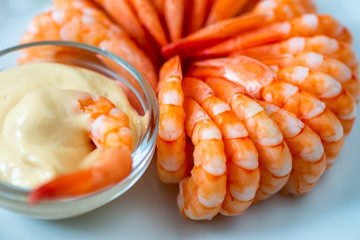 Boiled shrimps in circle, sauce.