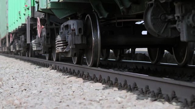 The wheels of old train on the railway track passing by camera. Close up shot