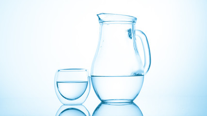 Jug and glass of water on white background