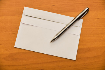 Envelope and ballpoint on table