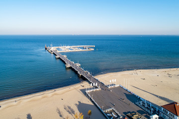 Wooden pier with harbor, marina with yachts and beach in Sopot resort near Gdansk in Poland in sunset light. Aerial view - obrazy, fototapety, plakaty