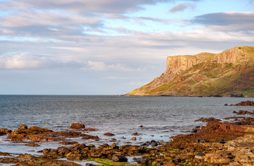 Fototapeta na wymiar Famous Fair Head cliff on the Northern coast of County Antrim, Northern Ireland, UK. Sunset light