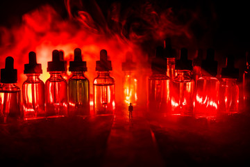 Silhouette of a man standing in the middle of the road on a misty night with giant glass bottles...