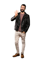 Fototapeta premium Handsome man with beard happy and counting four with fingers over isolated white background