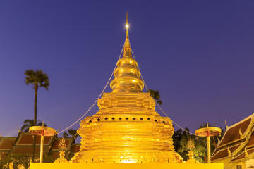 Golden buddha relic pagoda at Wat Phra That Si Chom Thong Worawihan at twilight, Chiang Mai, Thailand.