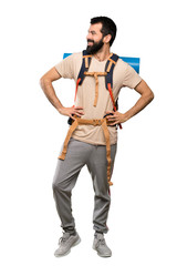 Hiker man posing with arms at hip and smiling over isolated white background