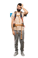 Hiker man with an expression of frustration and not understanding over isolated white background