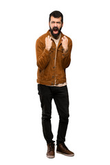 Fototapeta premium Handsome man with beard frustrated by a bad situation over isolated white background