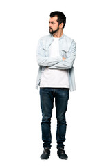Fototapeta premium Full-length shot of Handsome man with beard with confuse face expression over isolated white background