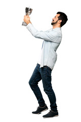 Naklejka premium Handsome man with beard holding a trophy.