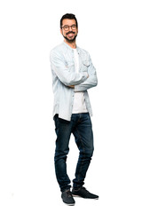 Full-length shot of Handsome man with beard with glasses and happy over isolated white background