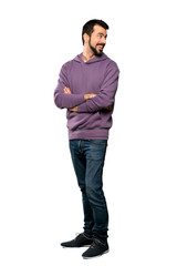 Fototapeta premium Full-length shot of Handsome man with sweatshirt with arms crossed and happy over isolated white background