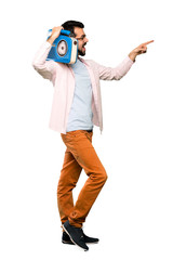 Handsome man with beard holding a radio