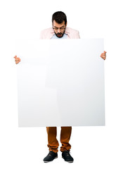 Handsome man with beard holding an empty placard