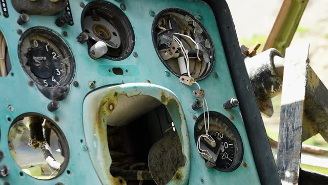 A steady, extreme close up shot of a broken blue dashboard belonging to an old, abandoned machinery.