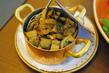 Cassolette of roasted mushrooms in a copper pan