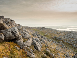 Dry stone wall in Burren national park, Ireland. Foggy morning.