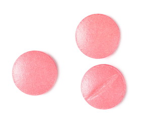 Pink pills, medicine isolated on white background, top view