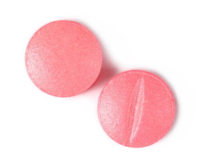 Pink pills, medicine isolated on white background, top view