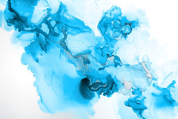 Blue alcohol ink texture with abstract washes and paint stains on the white paper background.	