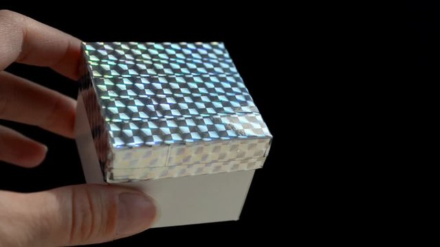 White gift box with rainbow scotch cover in hand, DIY idea, just showing