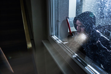 Burglar Looking Into A House Window - obrazy, fototapety, plakaty