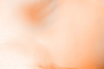 Fototapeta premium Orange alcohol ink texture with abstract washes and paint stains on the white paper background. 