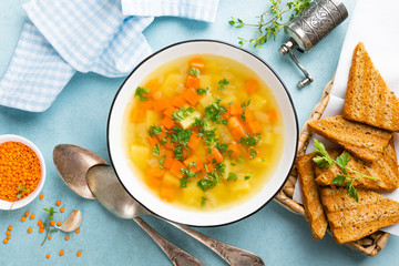 Lentil soup with vegetables and fresh parsley on plate