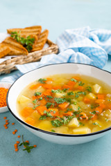 Lentil soup with vegetables and fresh parsley on plate