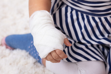 Little Girl With Bandage On Her Hand