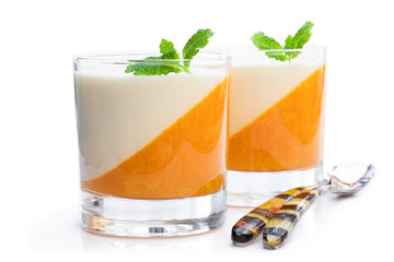 Panna cotta with orange jelly in clear glass isolated on white - obrazy, fototapety, plakaty