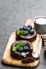 Chocolate fondant with blueberry on black stone background