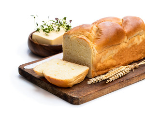 Homemade brioche loaf with butter and herb isolated on white