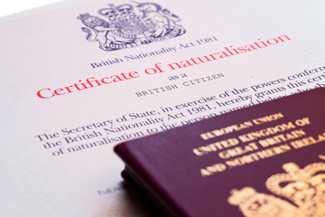 Image of the new issued pre brexit style British passports with naturalization certificate