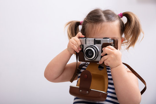 Little Girl Taking Picture Using Photo Camera
