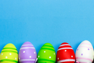 Painted easter eggs on blue background, copy spaсe