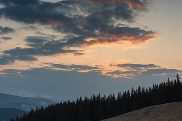 Rest on a mountainous valley with a view of the snow-capped peaks of Ukrainian carpathians in the spring period.