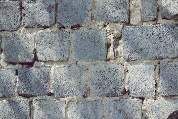 Texture of gray large stones of the old wall, in a natural environment