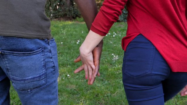 Interracial love,romance concept.Black man hand holding white woman hand