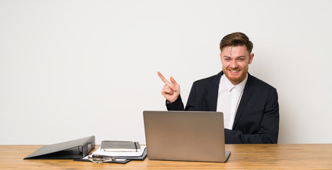 Businessman in a office pointing finger to the side