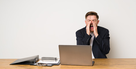 Businessman in a office shouting and announcing something
