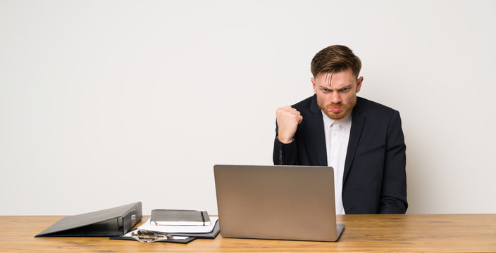 Businessman in a office with angry gesture