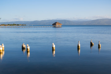 Wooden dock and a rustic hut make up for a beautiful rural pier at the Gulf of Cariaco in Venezuela
