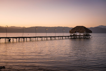 Wooden dock and a rustic hut make up for a beautiful rural pier at the Gulf of Cariaco in Venezuela