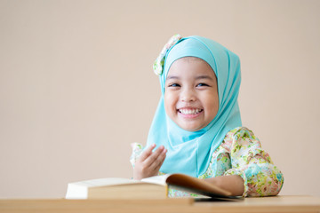 Happy Muslim kid during Quran during ramadan month.