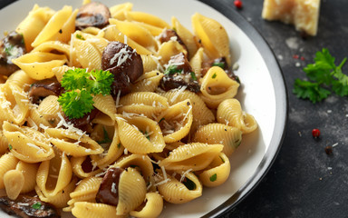 Conchiglie pasta with mushrooms, creamy sauce, parmesan cheese and herbs