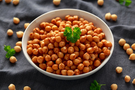 Roasted spicy chickpeas in white bowl. Healthy food
