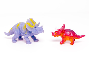Two toy dinosaurs on an isolated white background